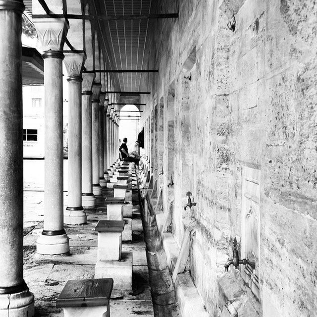 indoors, men, architecture, person, built structure, lifestyles, walking, the way forward, corridor, rear view, full length, leisure activity, in a row, architectural column, diminishing perspective, building, day