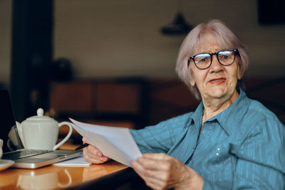 Portrait of smiling businesswoman at cafe