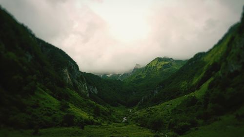 Idyllic shot of green valley against sky