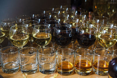 Tasting of scotch whisky and wines on the table. a bunch of glasses with alcoholic party drinks.