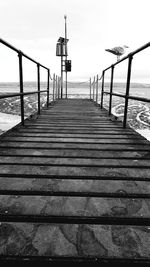 Pier over sea against sky