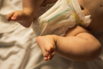 Lower section of a baby wearing a nappy