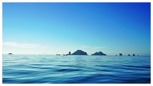 Scenic view of sea against clear blue sky