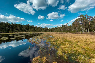 Scenic view of a moor lake in upper bavaria against cloudy and sunny sky