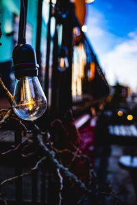 Light bulb hangs from fence