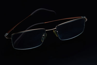 Close-up of sunglasses against black background