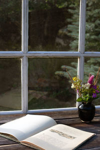 Close-up of flower vase on window sill
