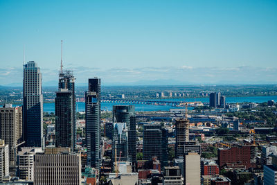 High angle view of cityscape against blue sky