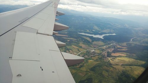 Cropped image of airplane flying over landscape