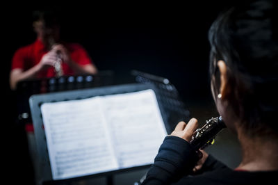 People playing clarinet in recording studio