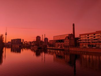 Bridge over river against sky during sunset