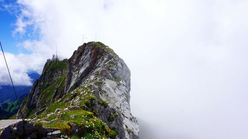 Low angle view of rocky mountains against sky