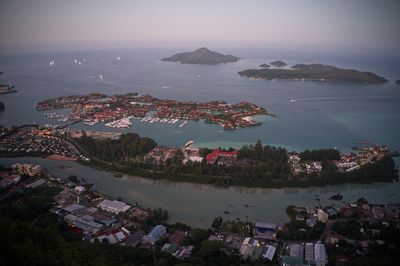 High angle view of townscape by sea against sky