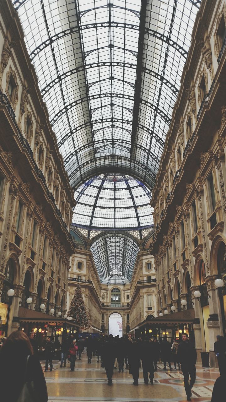 indoors, ceiling, large group of people, architecture, built structure, men, person, lifestyles, shopping mall, travel, famous place, leisure activity, travel destinations, interior, architectural feature, tourism, glass - material, illuminated, arch