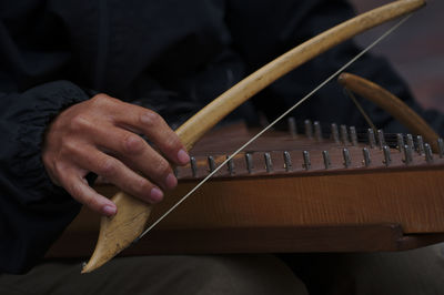 Midsection of man playing piano