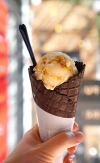 Close-up of hand holding ice cream