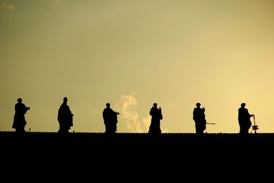 Silhouette statues against the sky