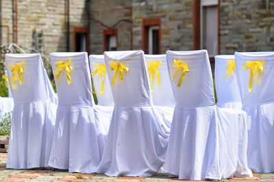 Clothes hanging on white wall against buildings in city