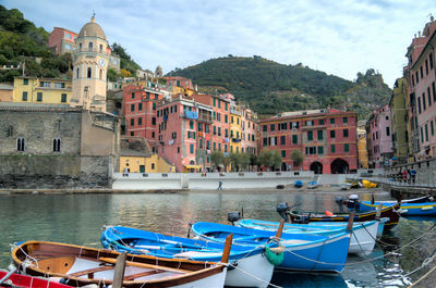 Boats moored by canal at cinque terre