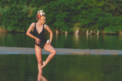 Full length of young woman in lake