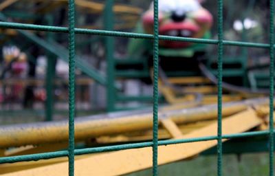 Close-up of boy in cage