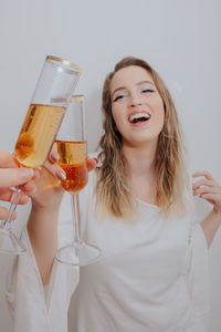 Smiling young woman holding wine