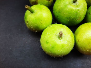 Close-up of green apples on table