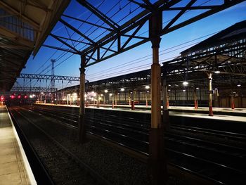 Train at railroad station against sky