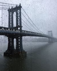 Close-up of suspension bridge against sky