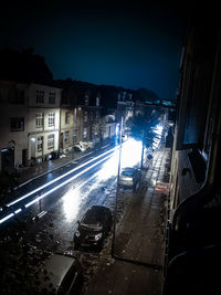 Illuminated city against sky at night