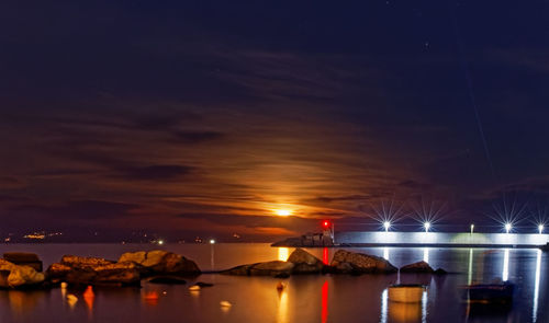 Scenic view of sea against sky during  moon dawn