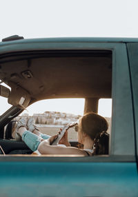 Portrait of woman sitting in car