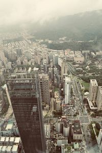 High angle view of modern buildings in city against sky