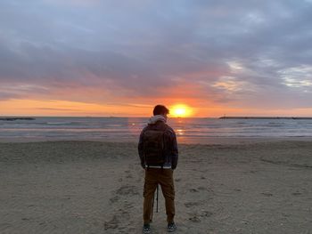 Rear view of man standing on beach