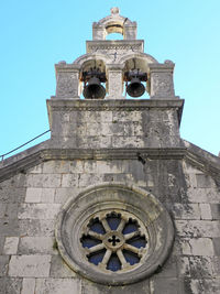 Low angle view of bell tower against blue sky