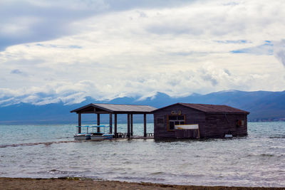 Gazebo by sea against sky