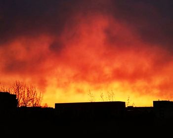 High section of silhouette built structure at sunset