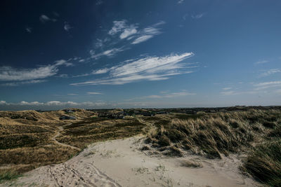 Scenic view of sand dune against sky