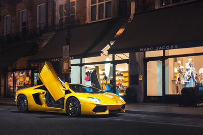 View of yellow car on city street