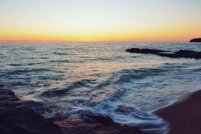 Scenic view of sea against clear sky during sunset
