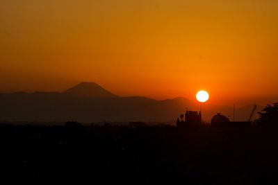 Scenic view of silhouette mountains against sky during sunset