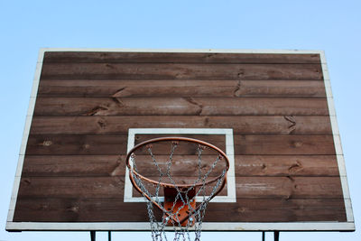 Basketball hoop, metal net and wooden backboard for game on blue sky background. basketball 