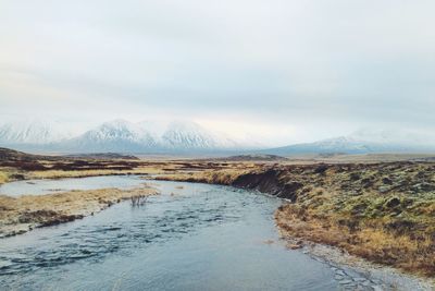 Scenic view of snow covered mountains against sky