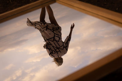 Low angle view of woman in water against sky