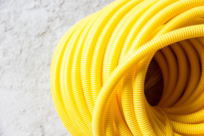 High angle view of yellow pipe on concrete