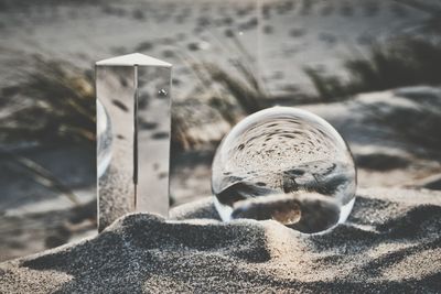 Close-up of cristal ball on the sand neach