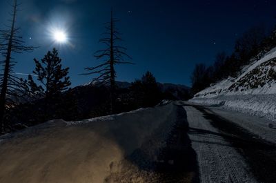 Road passing through snow covered landscape