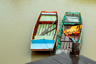 High angle view of pier by moored boats on river