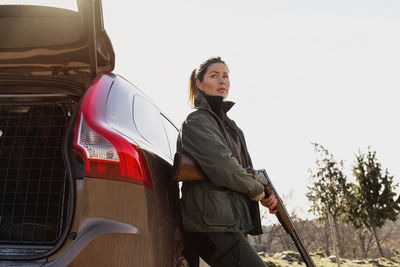 Woman standing near car