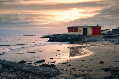 Scenic view of beach against sky during sunset